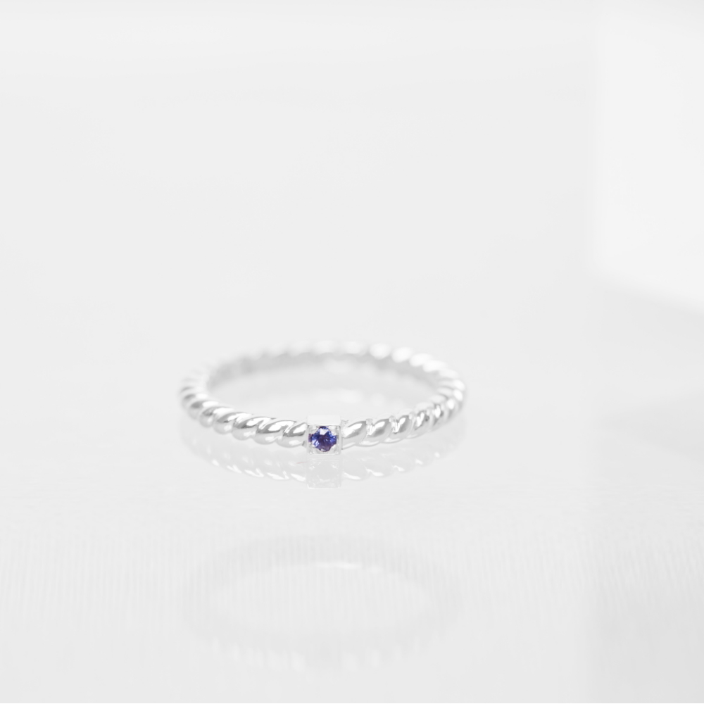 anneau solano torsadé en or blanc 18 carats avec une pierre saphir bleu