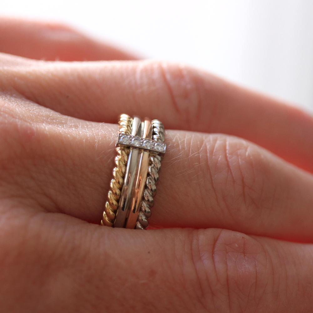 bague multiple avec des anneaux en or 18 carats et une barrette en or avec des diamants, portée sur un modèle doigt