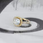 Bague solitaire en or jaune 18 carats serti un d'un diamant en pierre de centre entouré d'une torsade et de diamants sur la moitié de l'anneau.