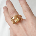 Bague en or jaune 18 carats serti de diamants en croisillons en les 2 anneaux ainsi qu'une citrine en pierre de centre portée sur une main